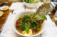 Mi Quang - rice noodles cooked in tumeric with braised pork belly, prawns and a soft-boiled egg