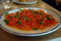 Salmon carpaccio with oil, lemon, cucumber, tomato, onion, basil