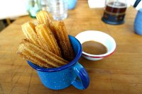 Traditional churros - coated in brown sugar and cinnamon. With Dulce de Leche for dipping