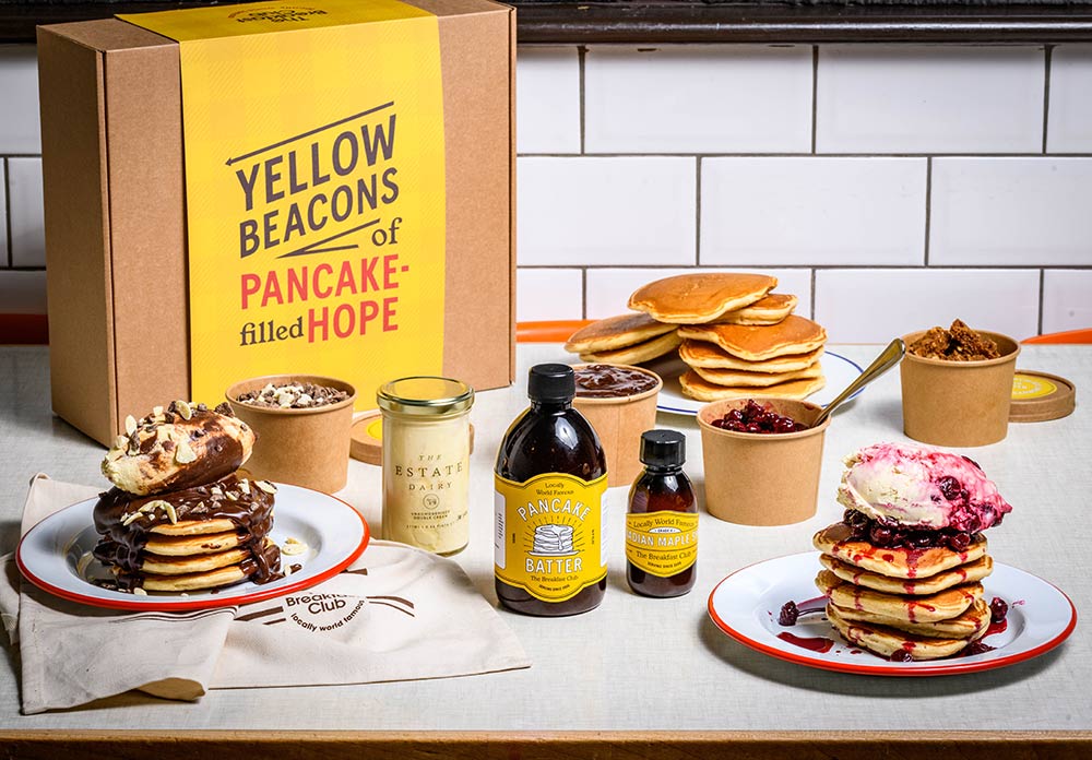 The Breakfast Club are delivering "Yellow Beacons of Pancake-filled Hope" (aka pancake kits)